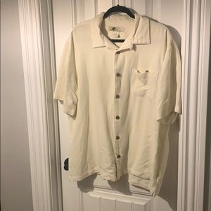 Cream colored short sleeve collared shirt
